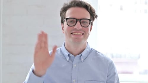 Engaging Young Adult Talking and Waving to Camera
