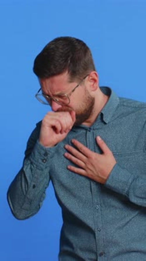 Man Coughing on Blue Background