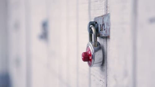 Combination Lock Secures White Painted Wood Surface