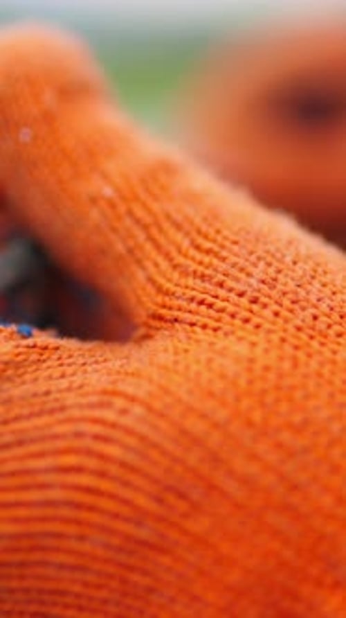 Hands Strip Insulation From Red and Black Wires