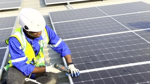 Technician installing solar cell. Installation and maintenance of solar cells on rooftop.
