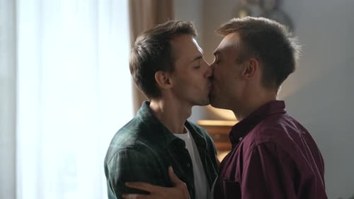 Young Couple Embracing Affectionately Indoors at Home