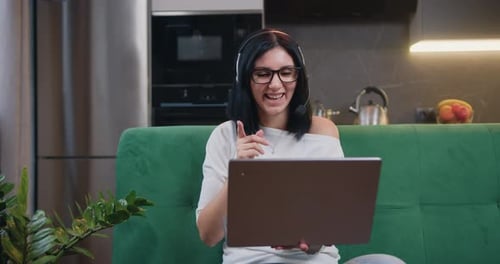 Woman Video Conferencing on Laptop at Home