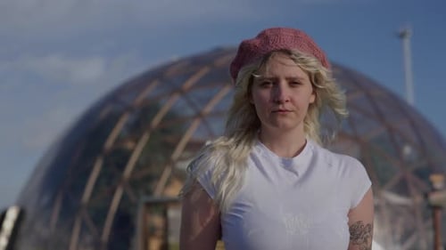 Woman in Beret Standing Near Geodesic Dome