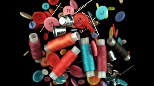 Floating Sewing Notions: Buttons, Thread, Needles on Black