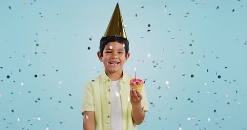 Happy birthday, child and portrait with confetti in party with cupcake, hat