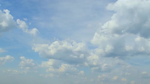 Birds Flying Across a Cloudy Blue Sky