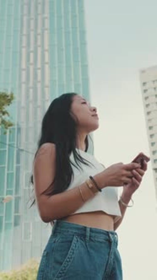 Young Woman Using Phone in the City