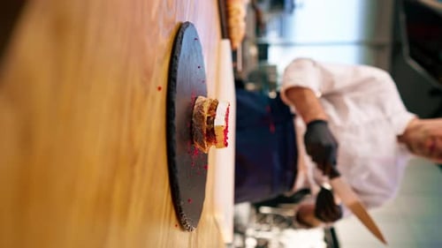 Vertical Video Closeup of a Finished Brie Cheese Sandwich with an Onion Base on Black Board Lying on