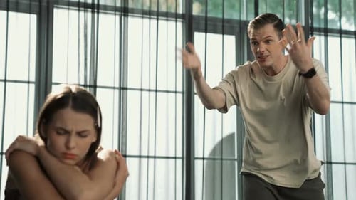 Upset Woman and Angry Man Arguing in Home