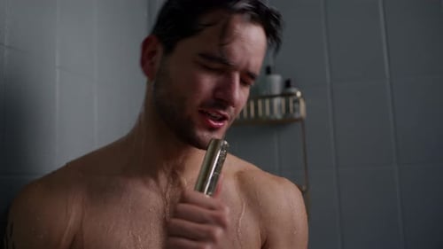 Man Singing in Shower Holding Shower Head