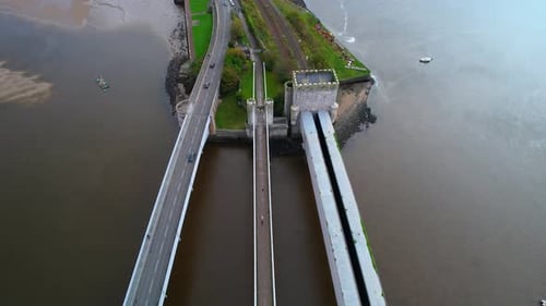 Bridges on Conwy river, North Wales in UK. Aerial forward tilt up reveal