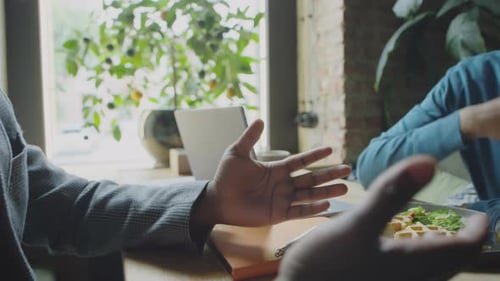 Business Partners Shaking Hands on Lunch in Cafe