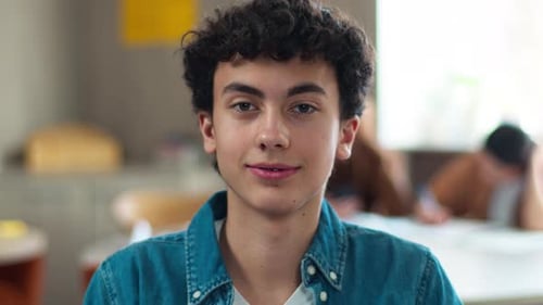 Smiling Teen with Curly Hair in Classroom