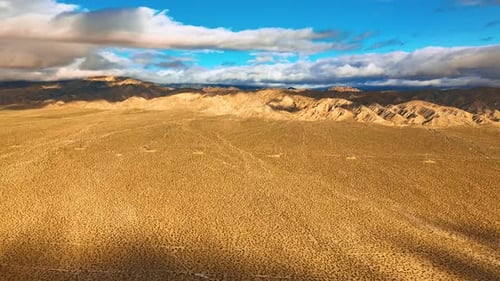 Plain deserted landscape surrounded by rocks.