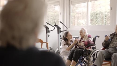 Seniors Exercising in a Rehabilitation Center with Assistance