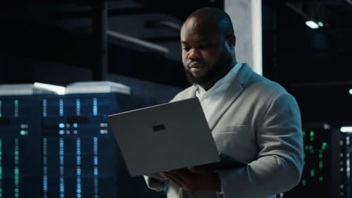 Data Center IT Expert Reviewing Performance Dashboards of Equipment Rigs