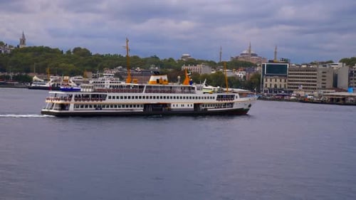 Large Passenger Ferry Cruises Past City Landscape