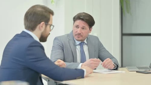 Businessman Talking with Partner in Office