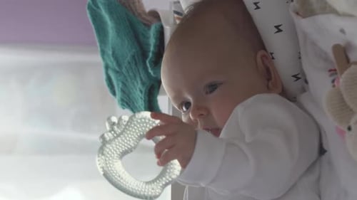 Closeup of Baby Girl Holding Teether Toy
