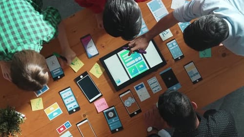 Top view of developer team working together to write idea on note. Convocation.