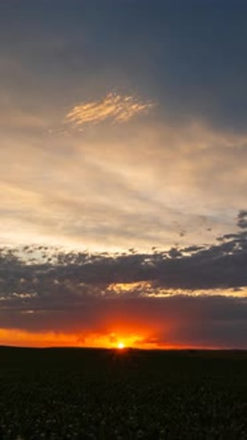Ruhiger Sonnenuntergangshimmel mit leuchtenden Wolken, die sich sanft über den Horizont bewegen