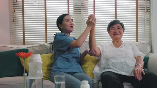 nurse provides physical therapy to the elderly at a nursing home