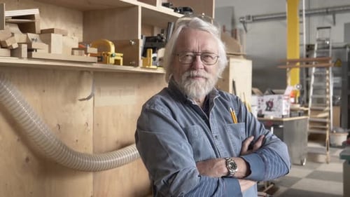 Smiling Senior Man in Woodworking Shop with Tools