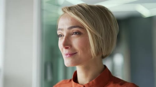 Close up portrait. Young blonde woman relaxing with closed eyes in a modern office. Beautiful