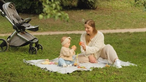 Mother Spends Time with Her Young Daughter Outdoors in the Park Young Mom Plays with Her Baby Child