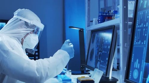 Doctor in Protective Suit is Doing a Science Experiments and Developing Vaccine in a Modern Lab