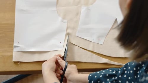 Woman Cutting Fabric With Scissors for Sewing Project