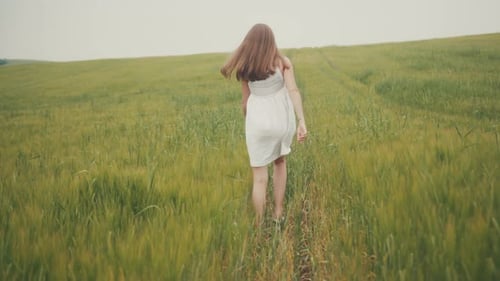 Back Footage of Young Girl Wearing White Dress Charming Lady Walking Through Green Field Summertime