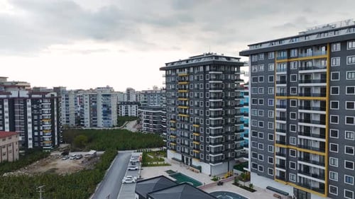 Aerial Video Facade of a New Complex Set Against a Dramatic Cloudy Sky Perfect Scenic View