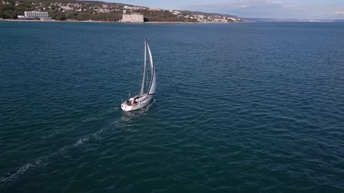 A Yacht with All Sails Set Races Across the Sea Propelled By the Wind Aerial View