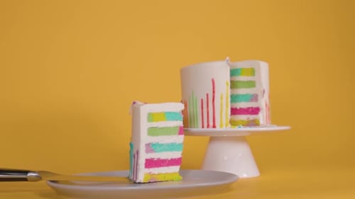 Colorful Layered Cake with White Frosting on Stand