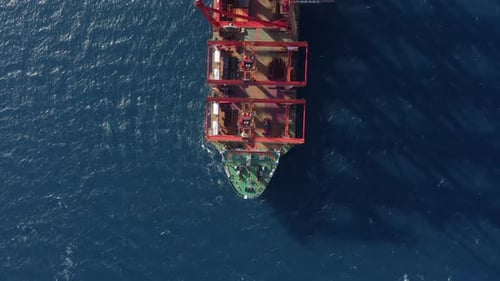 Cargo Ship loaded with new Port cranes at Sea, Aerial view.