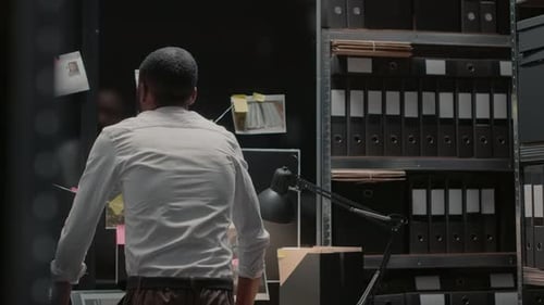 Detective Investigator Analyzing Case Evidence in Office