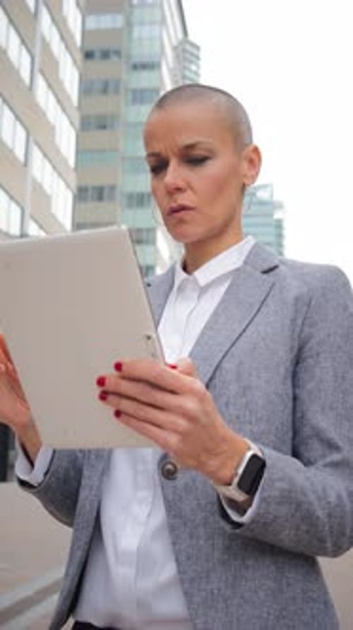 Focused Business Woman Using Tablet in City