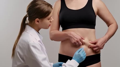 Healthcare Professional Examining Patient's Abdominal Area