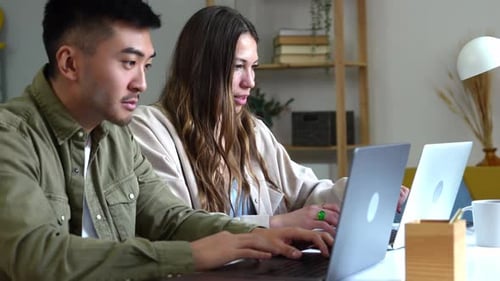 Young Adults Working on Laptops at Home Office