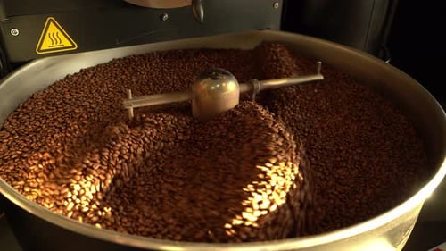 Coffee Beans Roasting and Swirling in Metal Bowl