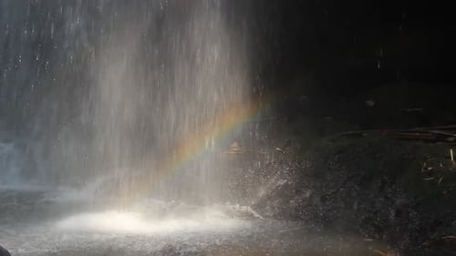blurry rainbow behind a fresh waterfall. beautiful scenery hidden in the middle of the rain forest