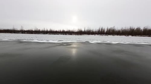 First Snow Blankets the Serene River Landscape in Winter Wonderland Beauty
