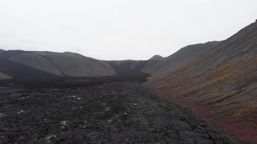 Champ de lave noire fumante dans le cratère du volcan Fagradalsfjall, en Islande.