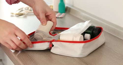 First Aid Kit Being Packed with Medical Supplies