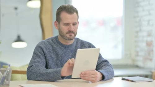 Man Using Tablet Device in Modern Workplace