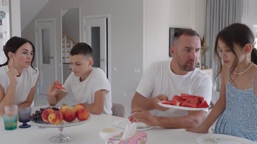 Family Enjoying Fresh Watermelon Together at Home
