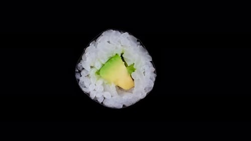 Rotating Maki Sushi Roll with Avocado on Black Background