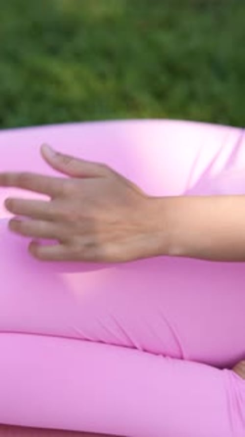 A Girl is Practicing Yoga in the Urban Park
